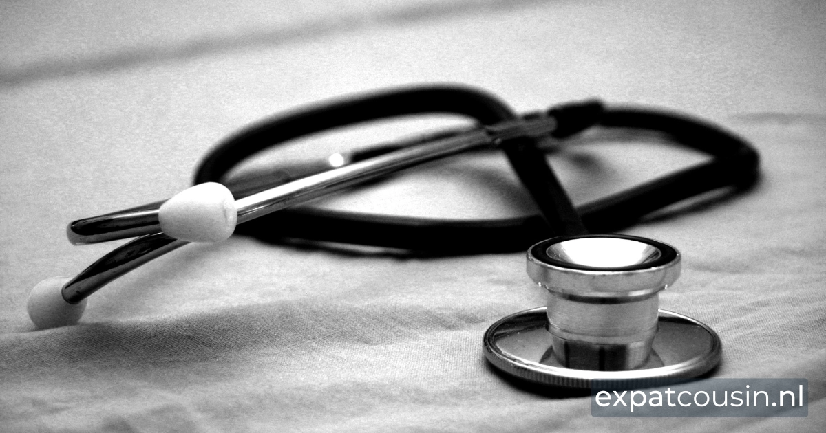 A grayscale picture of stethoscope on a bed with white sheets.