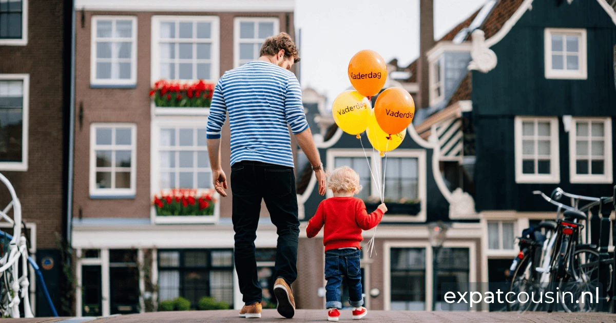 A father and a little child holding fathersday balloons walking over a bridge in a dutch city.