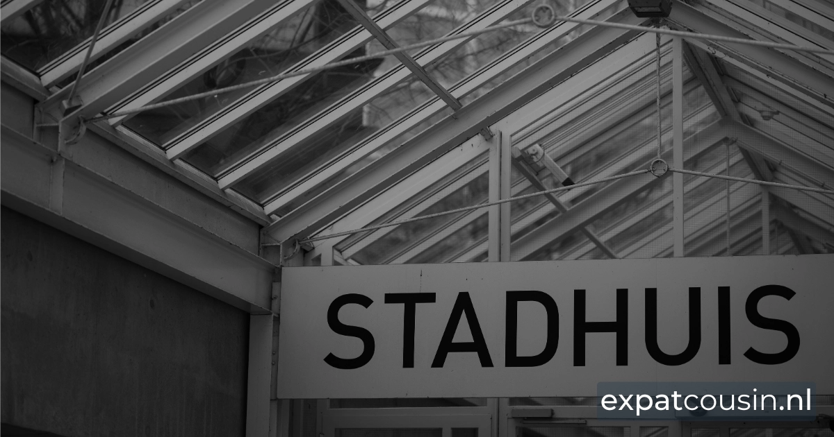 A grayscale close up of an upper section of a government building with the name board as Stadshuis.30-percent-ruling.webp